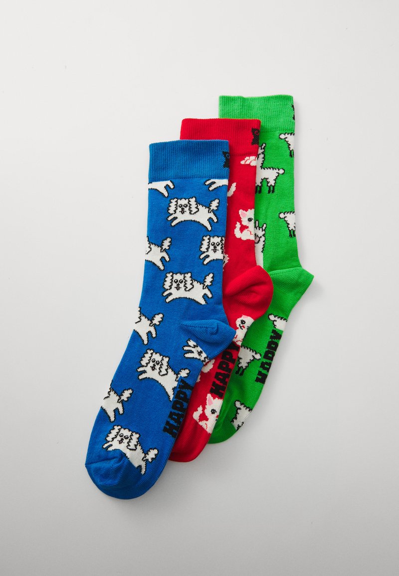Trois paires de chaussettes : bleues avec des impressions de chiens blanches, rouges avec des impressions de chiens blanches et vertes avec des impressions de chiens blanches. Texte "HAPPY" en noir sur chacune.