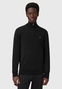 Sort zip-up sweater lavet af glat stof, med en høj krave og ribbede ærmekanter, samt et lille logo detalje på brystet.