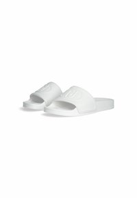 White rubber slide sandals featuring a wide strap with embossed logo, open toe design, and textured sole for grip.