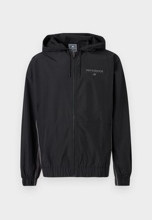 Black New Balance hooded zip-up jacket with elastic cuffs and reflective logo on the chest, designed for athletics and water resistance.