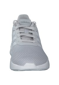 White Adidas athletic shoe featuring a mesh upper, elastic laces, three-striped accents, and a textured rubber sole.