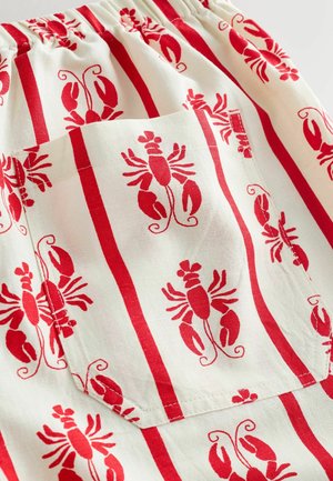 Raudonos ir baltos spalvos audinys su omarų raštais, vertikalaus dryžuoto dizaino. Įkomponuota kišenė praktiniam naudojimui.