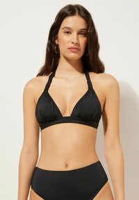 Svart bikiniuppsättning med triangulär bralette-topp med knytband och matchande högmidjade shorts, jämn textur.