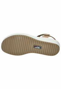 Light brown sandal with a textured rubber sole, white midsole, and adjustable straps. Features ridged bottom for traction and brand label.