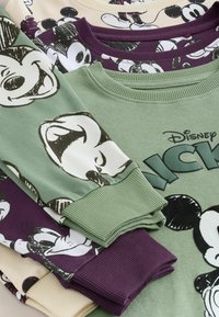 Collage of four sweatshirts featuring cartoon characters. Colors: green, purple, beige. Cotton material with ribbed cuffs. Various character prints.