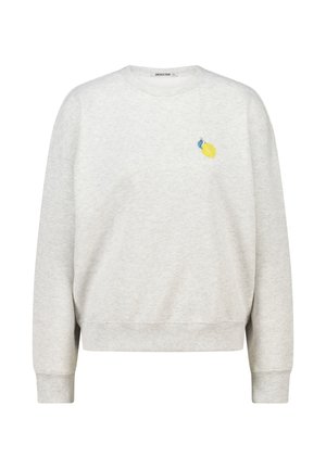 Sudadera gris claro de material suave, con un corte relajado, cuello redondo y pequeño bordado de limón amarillo en el pecho.