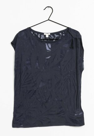 Top blu navy a maniche corte con una texture a motivo foglia, scollo rotondo e dettaglio con fiocco laterale. Realizzato in tessuto leggero e trasparente.