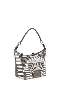 Sac à main à motif noir et blanc de forme arrondie, doté d'une longue bandoulière et d'une fermeture éclair, présentant des designs géométriques et des textures.