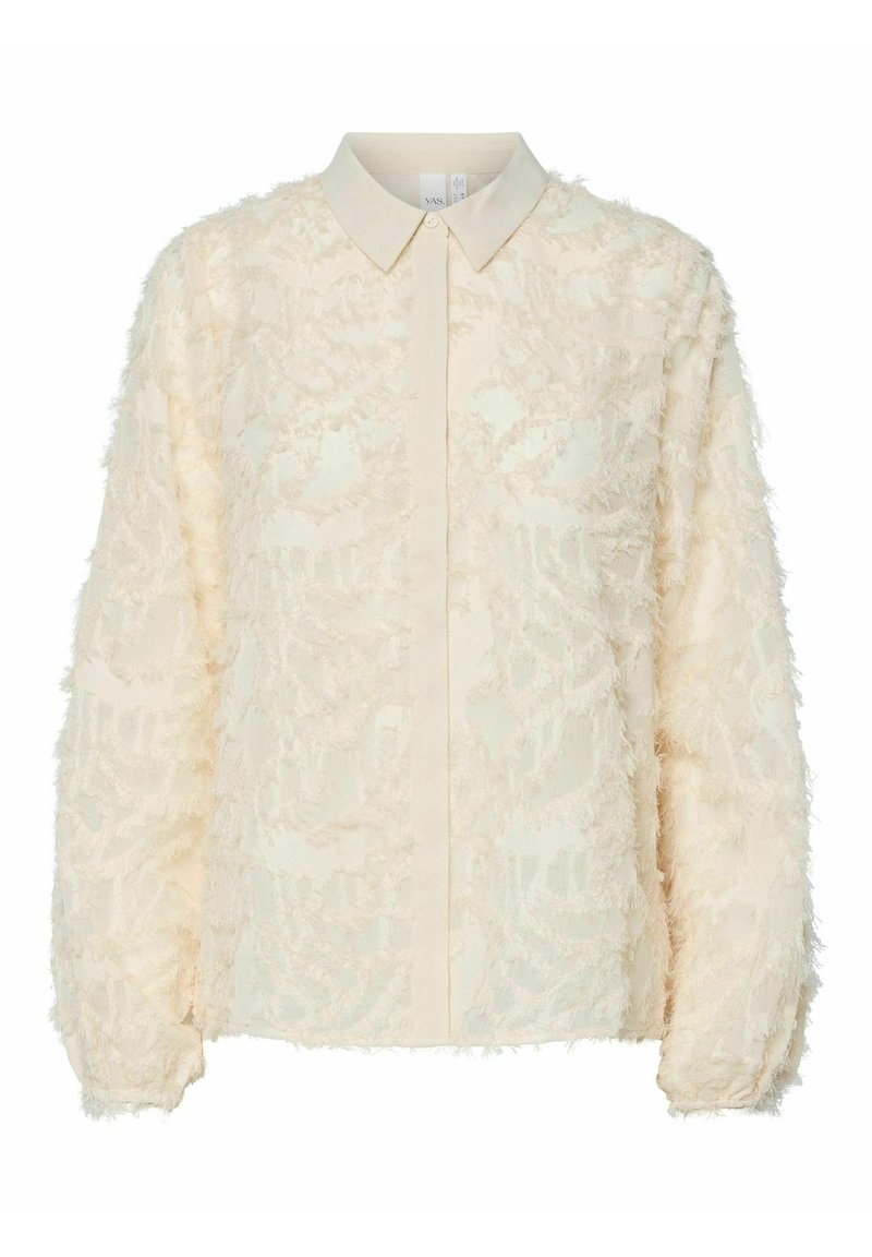 Cremfarbene Bluse aus einem strukturierten, ausgefransten Stoff mit floralem Muster. Sie hat einen Button-Down-Kragen und lange Ärmel.