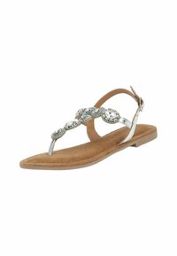 Sandali piatti con un plantare in suede color nocciola, cinturino alla caviglia in tonalità argento e dettagli decorativi circolari con strass trasparenti.