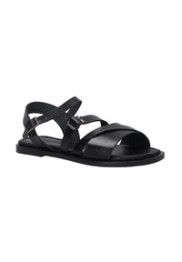 Zwarte leren sandalen met een verstelbare band, platte zool en open te ontwerp. Bevat kruisingbanden en metalen gespen voor het vastmaken.