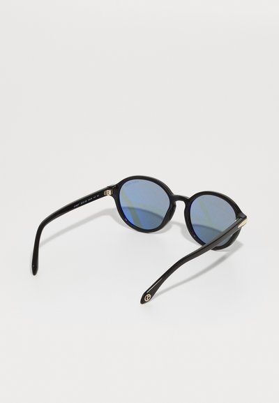 Round black sunglasses with gradient blue lenses, thin black acetate frame, and gold accent details on the temples.