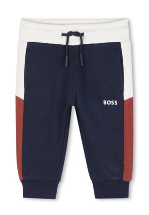 Pantalon de survêtement bleu marine avec ceinture blanche, panneaux latéraux rouille et blancs, poches avant, cordon de serrage et logo "BOSS" sur la cuisse gauche.