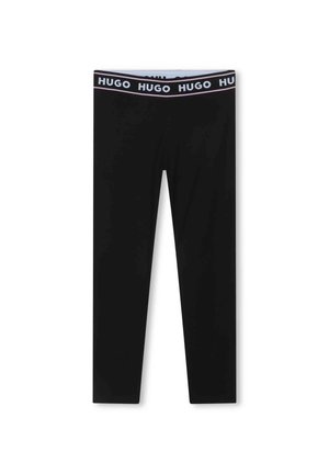 Μαύρα κολάν από ελαστικό ύφασμα. Διαθέτουν φαρδιά ελαστική ζώνη με επαναλαμβανόμενο λογότυπο "HUGO". Λείο υλικό και εφαρμοσμένος σχήμα.
