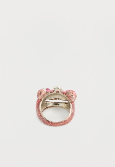 Ring featuring a pink glittery outer finish, rounded shape, bear ears, and a silver accent at the top. Smooth texture with a shiny surface.