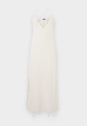 Dolga obleka svetlo bež barve, izdelana iz strukturnega blaga. Ima globok V-izrez, tanke prepletene naramnice in frufru podrobnost ob robu.