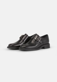 Scarpe in pelle nera con finitura liscia, dettaglio con una sola fibbia, punta leggermente arrotondata e tacco basso e testurizzato.
