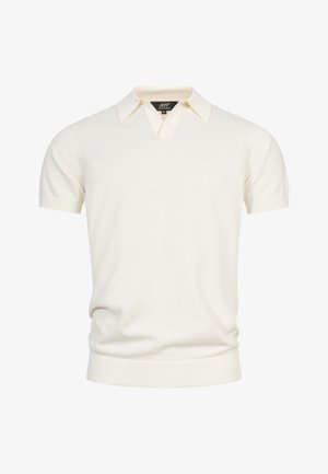 Polo à manches courtes de couleur crème avec un ourlet côtelé et un col, présentant une petite étiquette noire à l'intérieur de l'encolure.