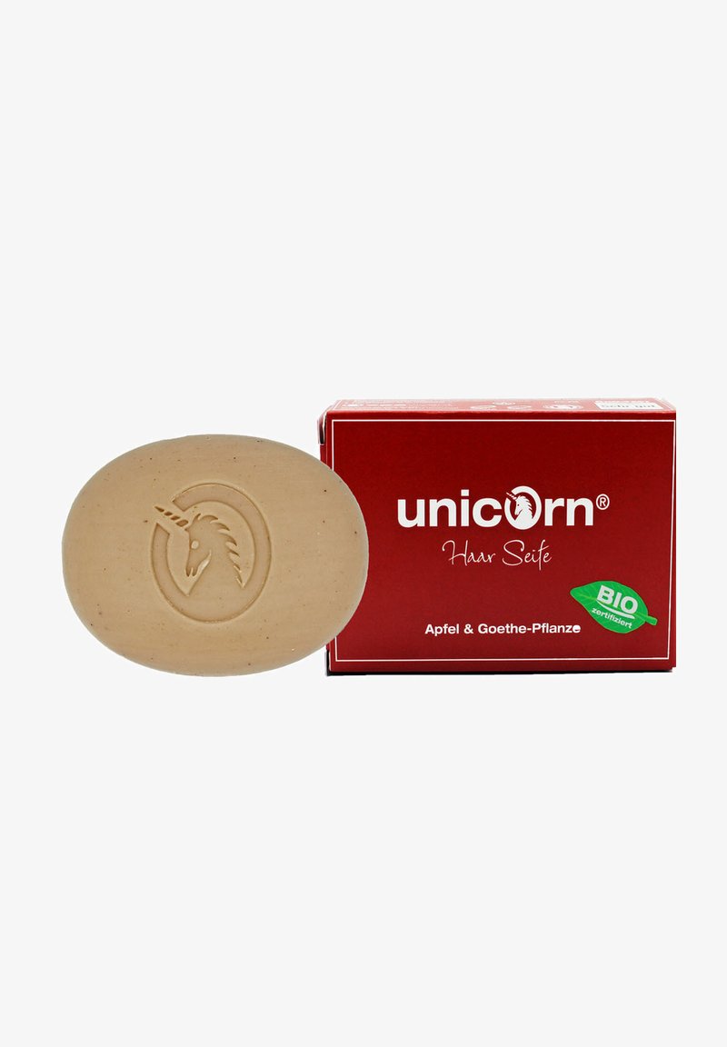 Brown oval soap with a unicorn emblem, packaged in a red box labeled "unicorn Haar Seife," featuring "Apfel & Goethe-Pflanze" text.