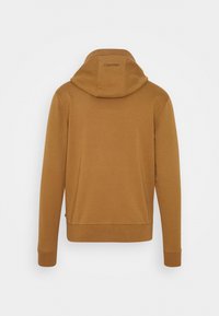 Sweat à capuche marron avec capuche, poignets et ourlet côtelés. Présente un logo Calvin Klein dans le dos, conçu dans un tissu doux et texturé.