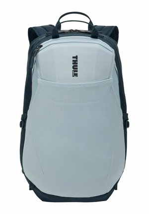 Sac à dos Thule gris clair et noir avec poche avant en mesh, poignée supérieure et bretelles rembourrées.