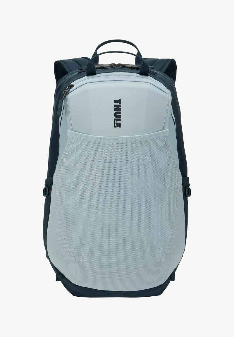 Sac à dos Thule gris clair et noir avec poche avant en mesh, poignée supérieure et bretelles rembourrées.
