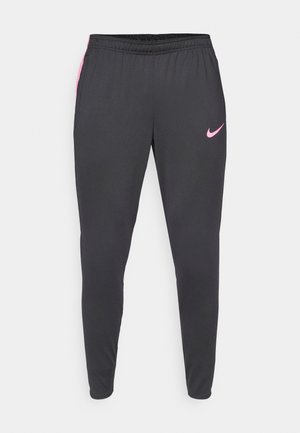Pantalons de sport noirs avec des accents roses, taille élastique, poches latérales et une coupe slim. Fabriqués à partir d'un matériau lisse et léger.