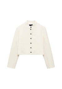 Veste ivoire courte avec un col haut et des manches longues. Présente des boutons noirs sur le devant et une texture lisse.