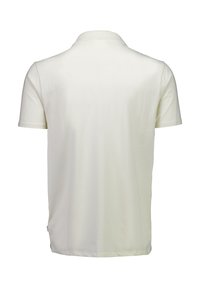 Koszulka polo z bawełny w kolorze écru, z klasycznym kołnierzykiem i krótkimi rękawami. Gładka faktura, luźny krój oraz boczna naszywka z logo.