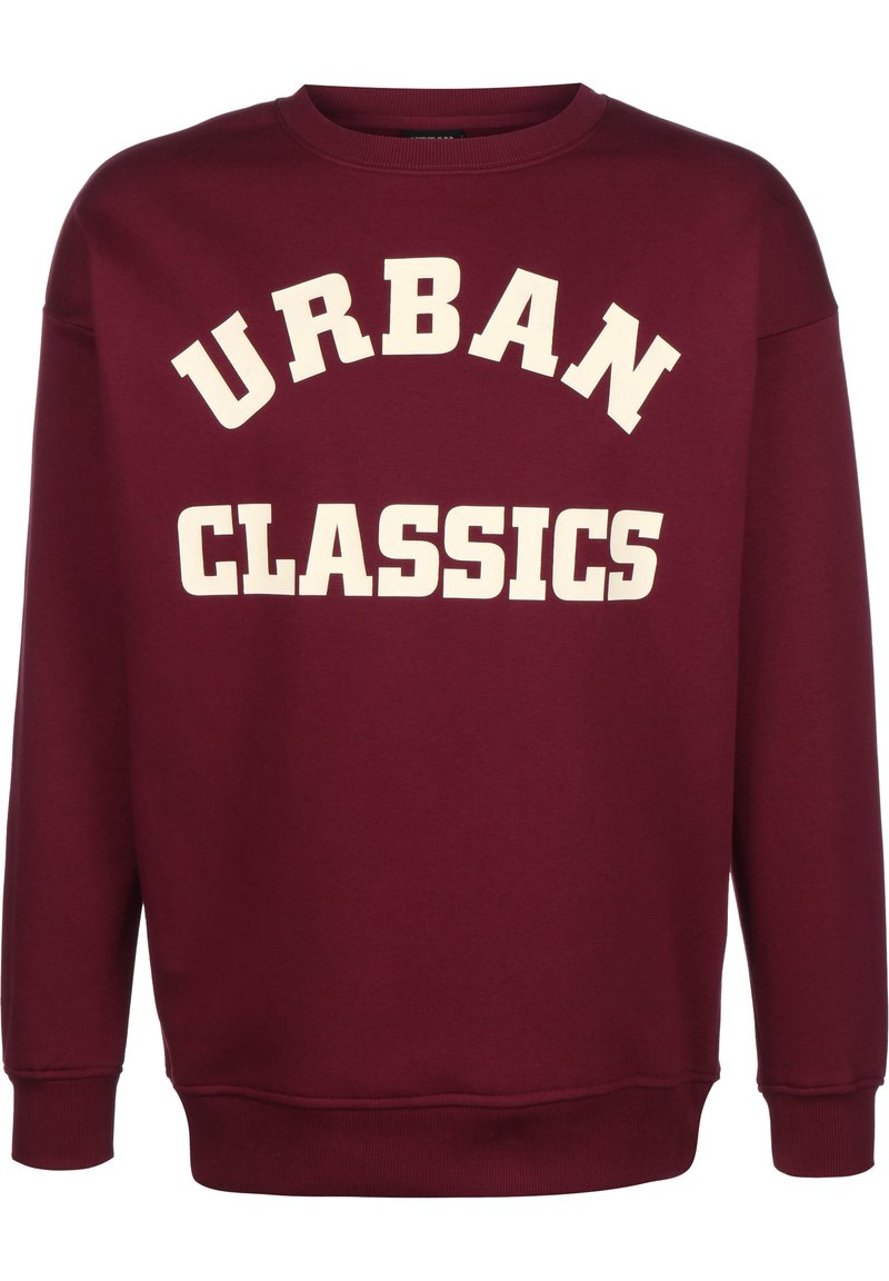 Bordová mikina s nápisem "URBAN CLASSICS" velkým krémovým písmem na hrudi, vyrobená z měkké tkaniny s žebrovanými manžetami a lemem.