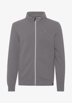 Harmaa vetoketjuhuppari korkealla kauluksella, pitkillä hihoilla, sivutaskuilla ja pienellä logolla rinnassa. Pehmeä kangas, jossa sileä pinta.