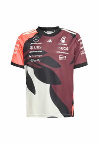 Jersey de manga corta en una combinación de colores burdeos y blanco, con patrones de hojas negras, impresiones de logotipo y cuello redondo.