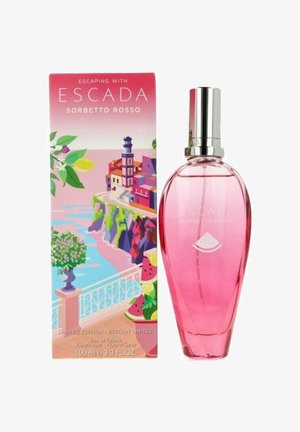 Vaaleanpunainen lasipullo pyöreällä muodolla, hopeakorkki ja vesimelonilogo. Mukana on värikäs, kuvioitu laatikko, jossa on rannikkokuva.