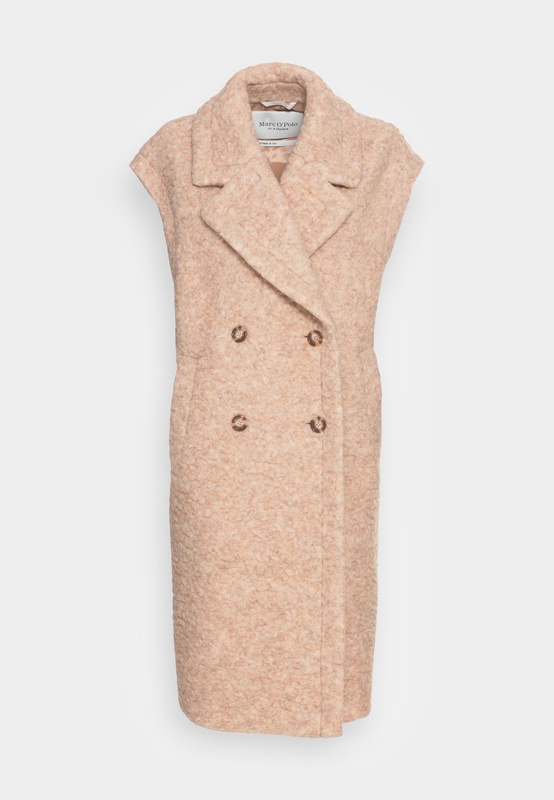 Manteau double boutonnage de couleur pêche en laine texturée. Présente de larges revers et deux boutons ronds, design sans manches.