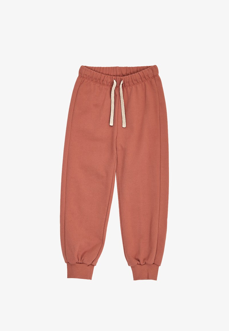 Pantalon de survêtement couleur rouille avec taille élastique, cordons blancs et chevilles retroussées, présenté à plat sur fond blanc.