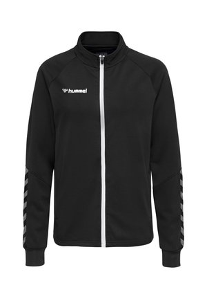 Schwarze Sportjacke mit Reißverschluss, weißem Reißverschluss, hummel-Logo auf der Brust und reflektierenden Chevron-Streifen an den Ärmeln.