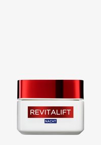 Vit krämbehållare med ett glänsande rött lock märkt "REVITALIFT NACHT," vilket indikerar en nattkrämprodukt.