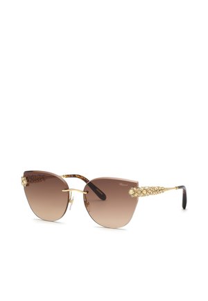 Brązowe gradientowe okulary przeciwsłoneczne w stylu cat-eye z pozłacanymi zdobionymi zausznikami i czarnymi końcówkami, z bezramkowym designem i noskami.