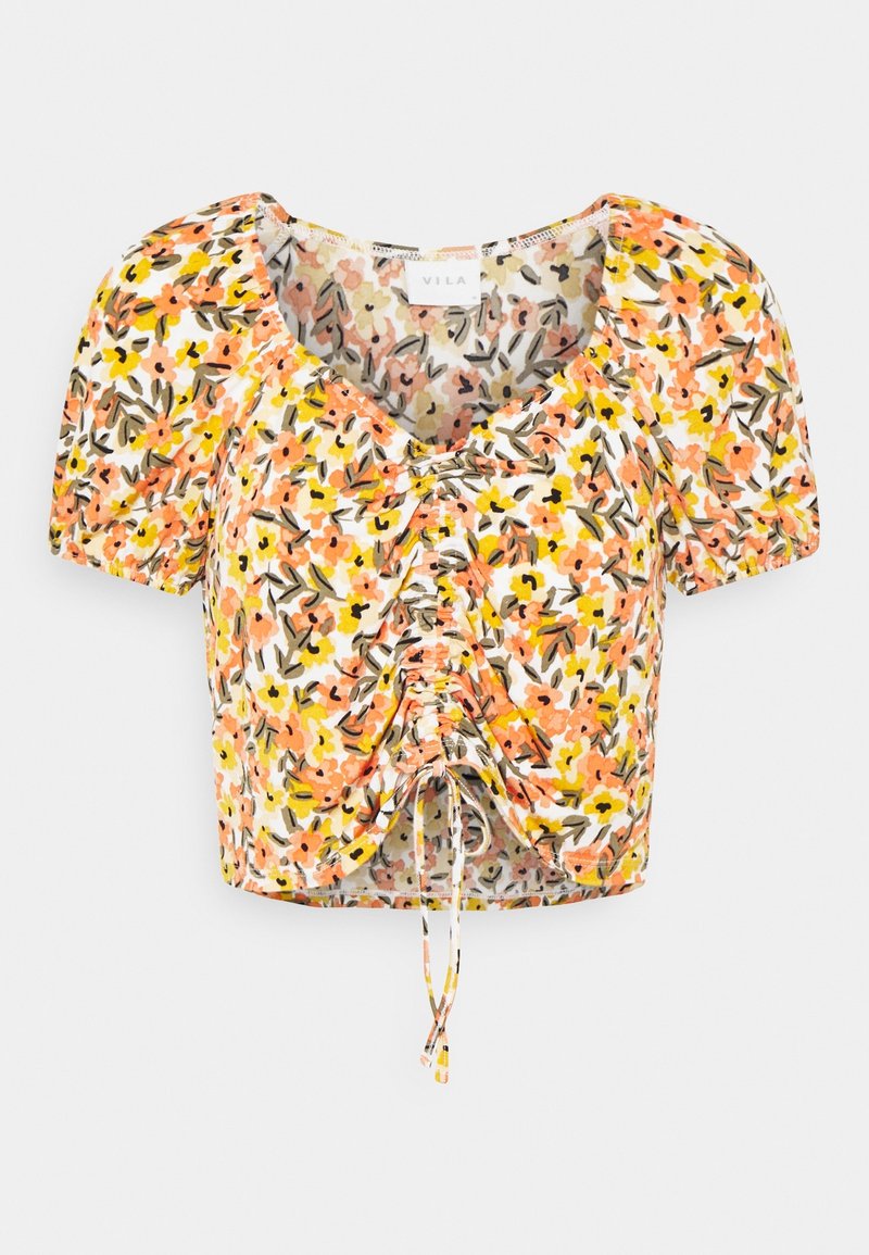 Haut à manches courtes et court avec un motif floral en orange, jaune et vert sur fond blanc ; avec un cordon de serrage à l'avant.