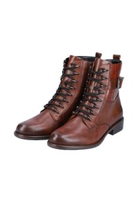 Bottes chevillières en cuir marron avec un panneau texturé, un design à lacets et une boucle sur le côté. Talon plat et bout rond, dotées de lacets noirs.