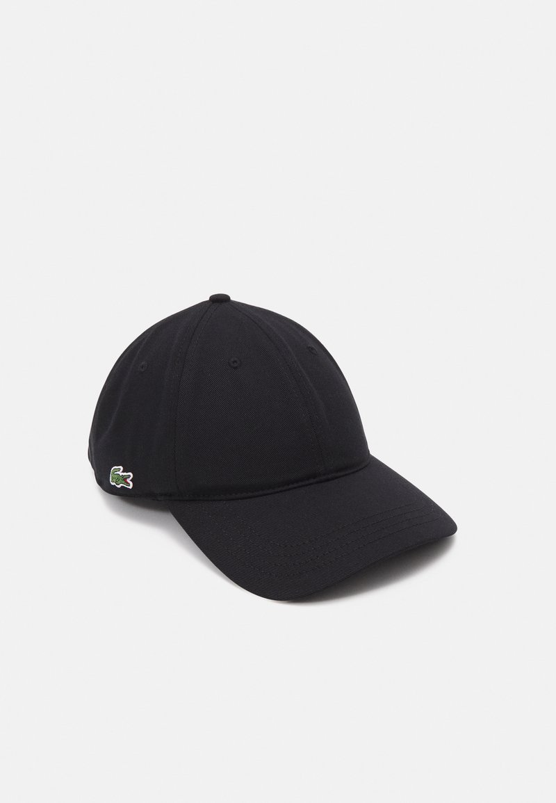 Black baseball cap made of fabric, featuring a curved visor, six-panel design, and a small green crocodile logo on the side.