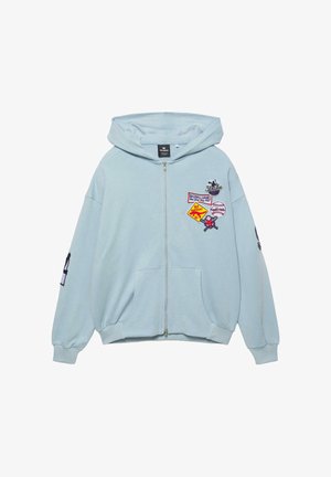 Svijetloplava trenirka na patentni zatvarač s prednjim džepovima, kapuljačom i šarenim detaljima u obliku bejzbol tema na prsima i rukavima.