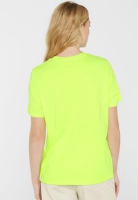 Neon yellow t-shirt with a crew neckline and short sleeves, made from soft, lightweight fabric. No visible patterns or hardware details.