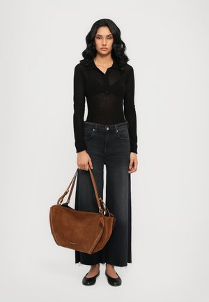 Black long-sleeve top, denim wide-leg jeans, brown suede handbag with adjustable strap, and black flats. Smooth texture and casual design.