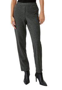 Black and white houndstooth patterned trousers with a relaxed fit, elastic waistband, and tapered legs; worn with black pointed toe heels.