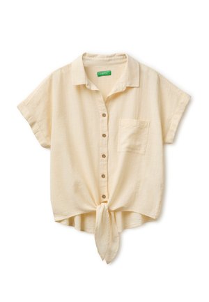 Beige overhemd met korte mouwen en knopen, voorzakje en geknoopte knoop aan de zoom, gemaakt van gestructureerde stof.