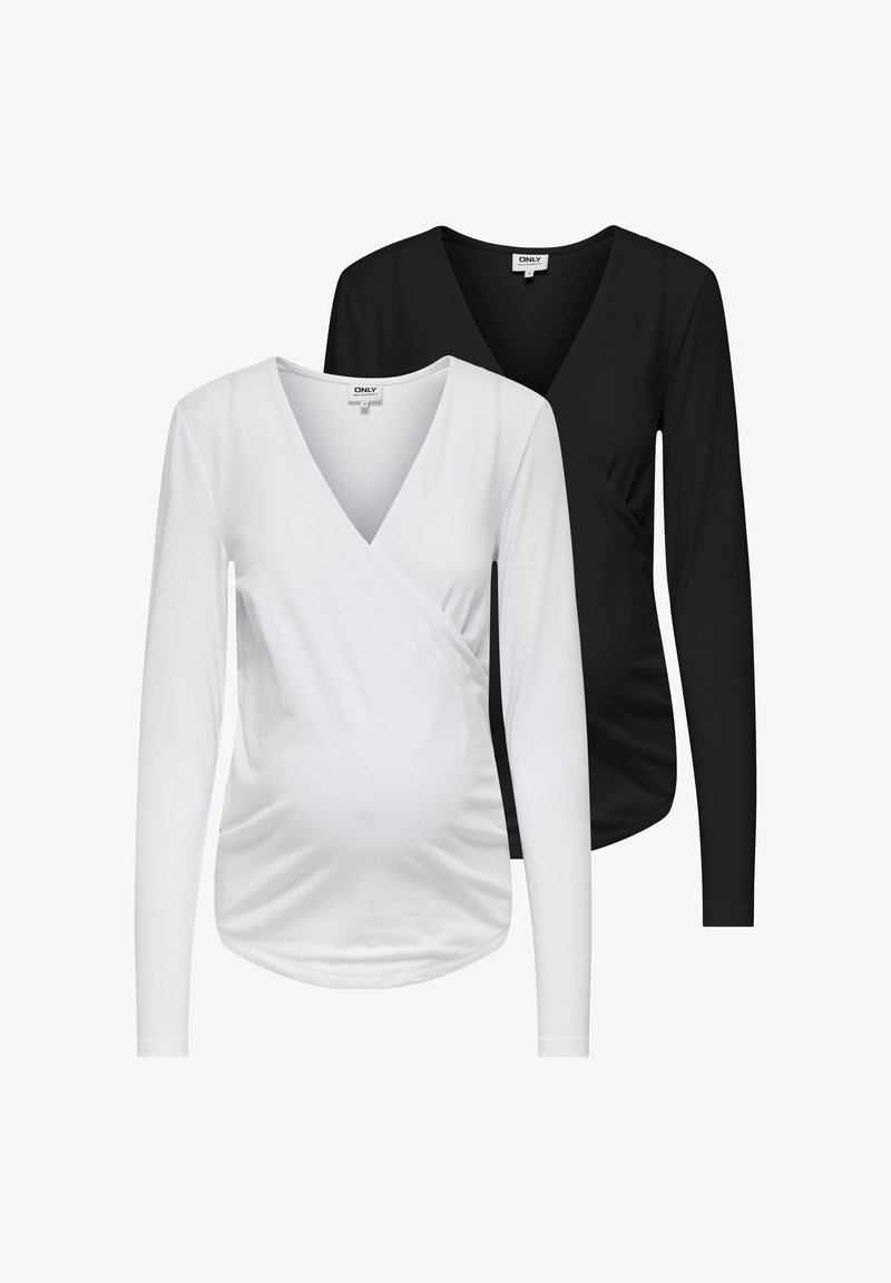 Dve dolgi majici z zaponko v beli in črni barvi, narejeni iz mehkega blaga, z V-izrezom in naborkom spredaj.