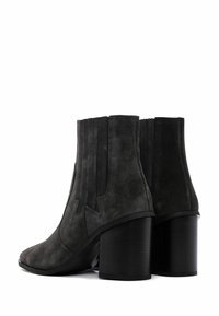 Gray suede ankle boots with vertical ribbed accents, pointed toe, and chunky black heels, featuring a smooth texture and clean lines.