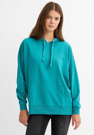 Sudadera con capucha en color verde azulado, con un bolsillo frontal, corte relajado, puños y dobladillo acanalados. Fabricada con una tela suave, cuenta con cintas en el cuello.