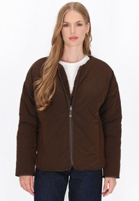 Brown quilted jacket with a zippered front, featuring a soft, fuzzy lining along the collar, and a relaxed fit with long sleeves.